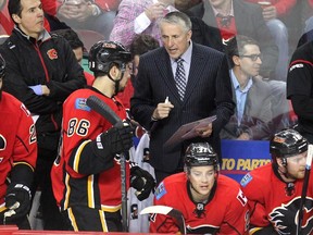 Calgary Flames head coach Bob Hartley talked with centre Josh Jooris on the bench during the first period against the Vancouver Canucks in NHL playoff action in game 4