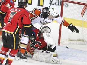 Anaheim's Corey Perry crashes into Calgary Flames goalie Karri Ramo as a shot sails into the net during a meeting between the teams last month. Perry and co. will present a big challenge for the Flames.