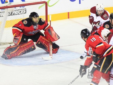 Calgary Flames goalie Jonas Hiller keeps his eye on the puck in a game against the Arizona Coyotes at the Saddledome in Calgary on Tuesday, April 7, 2015.