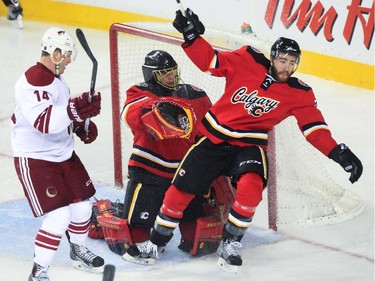 Calgary Flames player Thomas Brodie falls at the net at the Saddledome in Calgary on Tuesday, April 7, 2015.