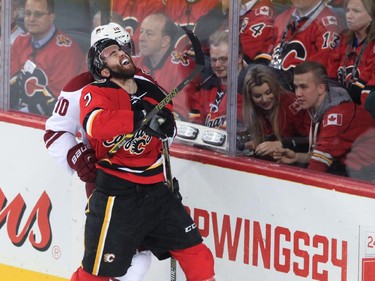 Calgary Flames defence Thomas Brodie takes a hit at the Saddledome in Calgary on Tuesday, April 7, 2015.