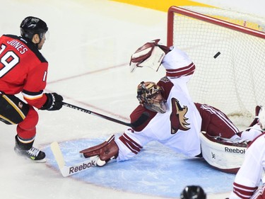 Calgary Flames player David Jones scores on Arizona Coyotes goalie Mike Smith at the Saddledome in Calgary on Tuesday, April 7, 2015.