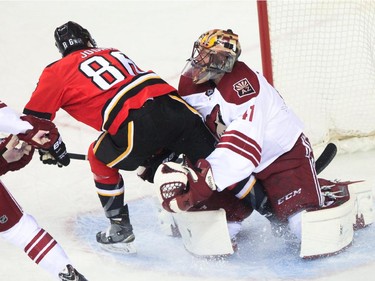 Arizona Coyotes goalie Mike Smith saves a shot from Josh Jooris at the Saddledome in Calgary on Tuesday, April 7, 2015.