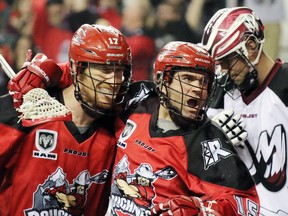 Calgary Roughnecks star Shawn Evans, right, celebrates with teammate Curtis Dickson after scoring on the Colorado Mammoth last Saturday. As the Riggers push for a playoff spot, Evans is gunning for the NLL single season scoring record.