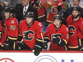 Calgary Flames rookie Johnny Gaudreau, second from right, celebrated after teammate Jiri Hudler scored the second Flames goal against the L.A. Kings during the first period on Thursday. With a 3-1 win, the Flames clinched a playoff spot for the first time since 2009. They will meet the Vancouver Canucks in the first round next week.