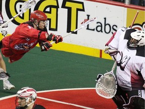 Calgary Roughnecks forward Curtis Dickson comes close in this scoring chance on Colorado Mammoth goaltender Alex Buque during National Lacrosse League action at the Scotiabank Saddledome on Saturday April 4, 2015.