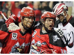 Shawn Evans, right, celebrates a goal with teammate Curtis Dickson during a game last season. The pair will go against each other on Friday when the Roughnecks visit Evans' new team, the New England Black Wolves.