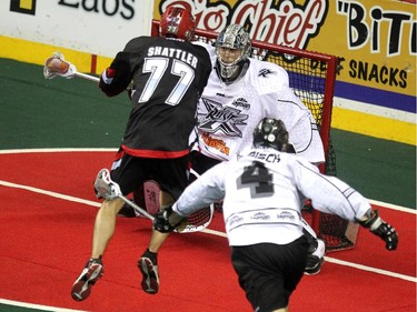 Calgary Roughnecks forward Jeff Shattler unleashed a shot and scored on the play against Edmonton Rush goalie Aaron Bold during first half NLL action at the Scotiabank Saddledome on April 10, 2015.