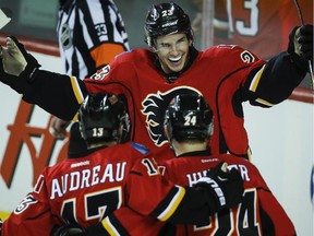 Calgary Flames Sean Monahan, centre, celebrates his goal with Johnny Gaudreau (13) and Jiri Hudler (24) during first period NHL hockey action against the Columbus Blue Jackets in Calgary, Saturday, March 21, 2015.