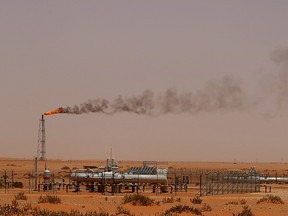 A flame from a Saudi Aramco oil installion known as "Pump 3" is seen in the desert near the oil-rich area of Khouris, 160 kilometres east of the Saudi capital Riyadh,