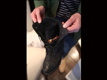 Mark shows his wife boot with a chicken wing found in it.