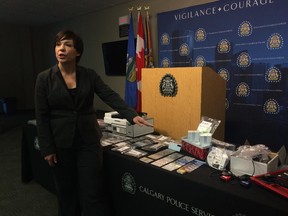 Staff Sgt. Kristie Verheul with the Calgary Police Service's economic crimes unit shows off blank cards, printers and other equipment in Calgary on Wednesday, April 1, 2015, seized from a southeast home in connection with a credit card and identification counterfeiting operation that resulted in charges laid against a Calgary man.