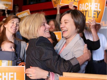 Leader of the NDP Rachel Notley, left and Shannon Phillips embrace before talking to supports at the Savoury Milagona Dance Cafe in Lethbridge on April 30, 2015.