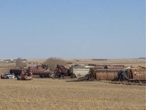 Workers are seen at the scene of a CN Rail derailment just northeast of Calgary along Range Road 271, on April 10, 2015.