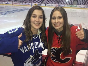 Twenty-one-year-old Francesca Moore, left, and Chelsea Horsman, 20, get ready for Game 5 in Vancouver on Thursday, April 23, 2015. They both live in Abbotsford, B.C.