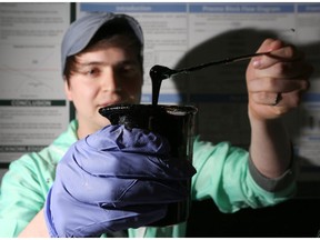 University of Calgary engineering students Julian Muila with his teams mechanical conversion reactor.