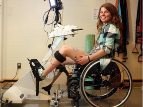 Amanda Timm can power a bike for the first time after a spinal cord injury, with a new functional electrical stimulation bicycle that provides surface electrical stimulation of the muscles, at the Thrive Centre at the University of Calgary in Calgary, on April 22, 2015.