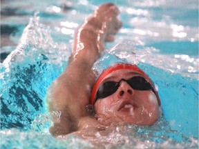 Calgary's Russell Wood, seen working on his back stroke during this 2013 file photo, broke the Canadian record in the men's 50 back with a time of 25.13 on Thursday night at the Canadian trials in Toronto.