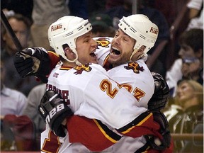 Calgary Flames forward Martin Gelinas, right, celebrates his series-winning goal in Game 7 of the opening round of the 2004 NHL playoffs against Vancouver with teammate Andrew Ference. The similarities between that underdog team and this one are many.