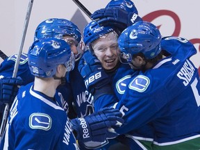 Vancouver Canucks left wing Ronalds Kenins (41) celebrates his goal with his teammates during the third period of game 2 of the NHL Western Conference first round playoff hockey series against the Calgary Flames in Vancouver, B.C. Friday, April 17, 2015.
