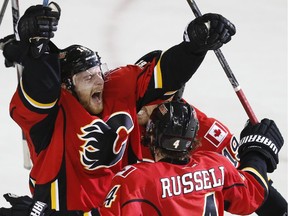 Matt Stajan #18 celebrates his game winning goal with Kris Russell #4 and David Jones #19 against the Vancouver Canucks in Game 6.
