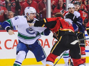 Vancouver's Alex Burrows was called for an instigator penalty in this fight with Calgary's Kris Russell late in Game 3. The Canucks were let off the hook by the NHL from supplemental discipline on Monday.