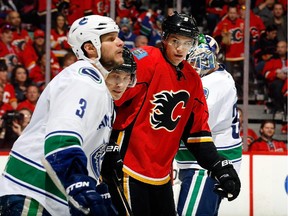 Calgary Flames forward Joe Colborne skates against Vancouver Canucks rival Kevin Bieksa during Game 3 on Sunday.