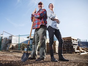Amanda Weightman and Paul Hughes, executive director and director of operations of Grow Calgary, stand in front of a pallet structure that has yet to be approved by the city in northwest Calgary on Wednesday, April 8, 2015.  Grow Calgary is an volunteer-driven urban agriculture program that grows food and then donates it to the food bank.