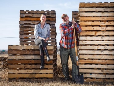 Amanda Weightman and Paul Hughes, executive director and director of operations of Grow Calgary, stand in front of a pallet structure that has yet to be approved by the city in northwest Calgary on Wednesday, April 8, 2015.  Grow Calgary is an volunteer-driven urban agriculture program that grows food and then donates it to the food bank.