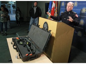Calgary Police Service Superintendent Kevan Stuart talks with the media behind a police Colt C8 rifle similar to one which was stolen from an off duty officer's private vehicle on Saturday evening.