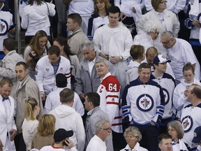 Prime Minister Stephen Harper looks up at the score board prior to the puck drop in game four of NHL playoff action between the Winnipeg Jets and the Anaheim Ducks in Winnipeg on Wednesday, April 22, 2015.