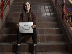 Renae McArthur, a student at the University of Calgary's Haskayne School of Business displays a photo of what she and her team hope their new Securelet bracelet will look like when it hits the market.