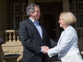 Premier Rachel Notley and outgoing premier Jim Prentice shake hands outside Government House on May 12, 2015.