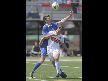 Foothills FC player Dominic Russo, centre, competes with the Puget Sound Gunners for control of the ball at Hellard Field in Calgary on Sunday, May 17, 2015. The Foothills FC under-23 team won over the Puget Sound Gunners, 2-1, in their home opening game.