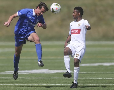 Foothills FC player Mitchell Bauche, right, moves in to block a Puget Sound Gunner header at Hellard Field in Calgary on Sunday, May 17, 2015. The Foothills FC under-23 team won over the Puget Sound Gunners, 2-1, in their home opening game.