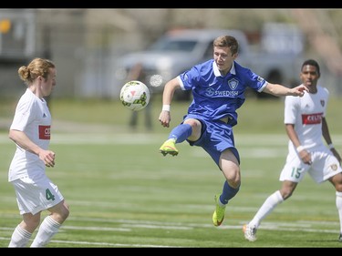 Puget Sound Gunner Adam Jones jumps to stop a long pass by the Foothills FC at Hellard Field in Calgary on Sunday, May 17, 2015. The Foothills FC under-23 team won over the Puget Sound Gunners, 2-1, in their home opening game.