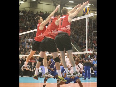 Team Canada blocks a Team Cuba spike at the Calgary Corral in Calgary on Sunday, May 17, 2015. Team Canada won over Team Cuba, 3-0, in the FIVB World League international men's volleyball tournament.