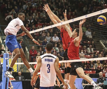 Team Cuba player Felix Emilio Chapman Piñeiro delivers a powerful revenge spike against Team Canada during a heated back and forth at the Calgary Corral in Calgary on Sunday, May 17, 2015. Team Canada won over Team Cuba, 3-0, in the FIVB World League international men's volleyball tournament.
