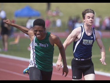 Competitors fight for their position in the boys 100 metre dash at the Foothills Athletic Park in Calgary on Saturday, May 23, 2015.