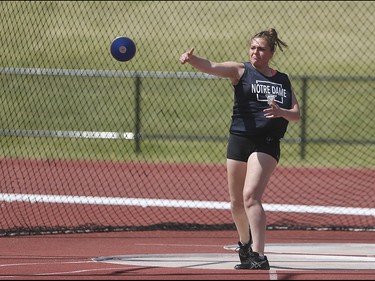 Kaylee Kowch of Notre Dame High School hurls a discuss at Foothills Athletic Park in Calgary on Saturday, May 23, 2015.