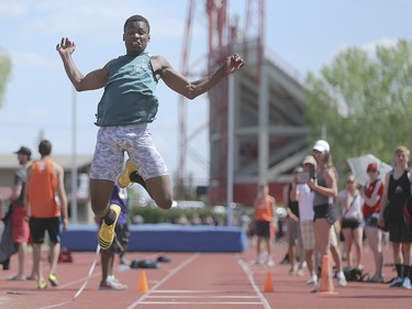 A triple jump competitor sails through the air towards a waiting sand pit at the CSHSAA championship track & field meet at the Foothills Athletic Park in Calgary on Saturday, May 23, 2015.