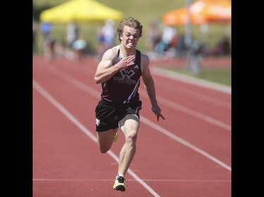 Donovan Sladek, centre, wins in the 100 metre boys intermediate dash at the Foothills Athletic Park in Calgary on Saturday, May 23, 2015. Calgary's high school track and field athletes competed Saturday in the CSHAA championships.