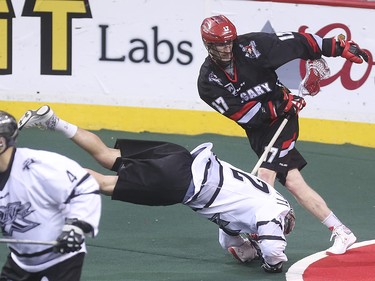 Roughneck Curtis Dickson, top, brings down an Edmonton Rush player at the Scotiabank Saddledome in Calgary on Saturday, May 23, 2015. The Calgary Roughnecks lost to the Edmonton Rush, 4-1, in game three of the National Lacrosse League west division final.