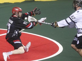 Roughneck forward Curtis Dickson attempts to block Edmonton Rush forward Mark Matthews from scoring on an empty net at the Scotiabank Saddledome in Calgary on Saturday, May 23, 2015. The Calgary Roughnecks lost to the Edmonton Rush, 4-1, in game three of the National Lacrosse League west division final.