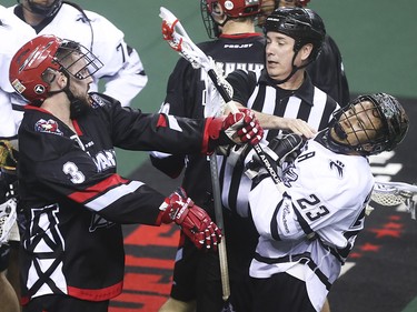Roughneck defence Dan MacRae, left, and Edmonton Rush Transition offence Jarrett Davis get into a scrap at the Scotiabank Saddledome in Calgary on Saturday, May 23, 2015. The Calgary Roughnecks led the Edmonton Rush, 9-7, in the first half of game two of the National Lacrosse League west division final.