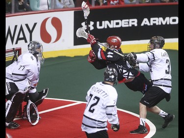 Roughneck forward Dane Dobbie, centre, makes a shot on Edmonton Rush goalie Aaron Bold at the Scotiabank Saddledome in Calgary on Saturday, May 23, 2015. The Calgary Roughnecks won over the Edmonton Rush, 12-9, in game two of the National Lacrosse League west division final.