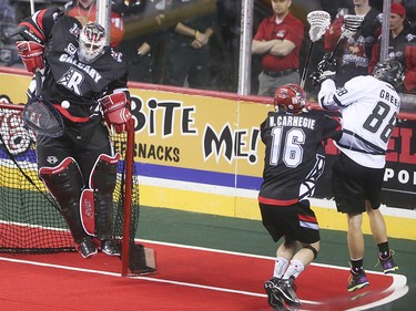 Roughnecks goalie Mike Poulin jumps to block a shot on net at the Scotiabank Saddledome in Calgary on Saturday, May 23, 2015. The Calgary Roughnecks won over the Edmonton Rush, 12-9, in game two of the National Lacrosse League west division final.