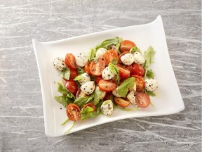 The spiciness of the arugula is offset by the mildness of the bocconcini cheese in this Arugula Caprese Salad.