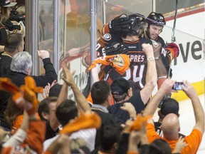 Anaheim Ducks' fans and players celebrate Anaheim Ducks' right wing Corey Perry's (10) goal during the second period of Game 1 in the second round of the NHL Stanley Cup hockey playoffs, Thursday, April 30, 2015, in Anaheim, Calif.