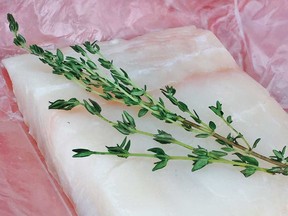 Halibut with a sprig of thyme.